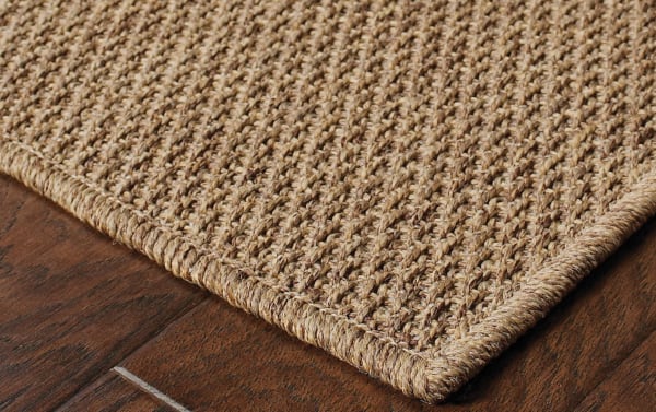 Close-up of the Saba 5' x 8' brown solid indoor/outdoor rug with rustic seagrass texture, power-loomed polypropylene material.