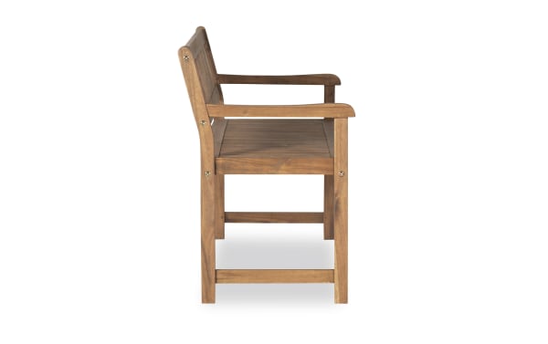 Walton Brown Teak Outdoor Bench in solid acacia wood with traditional style, featuring slatted seat and backrest, armrests, and sturdy construction for porch or patio seating.