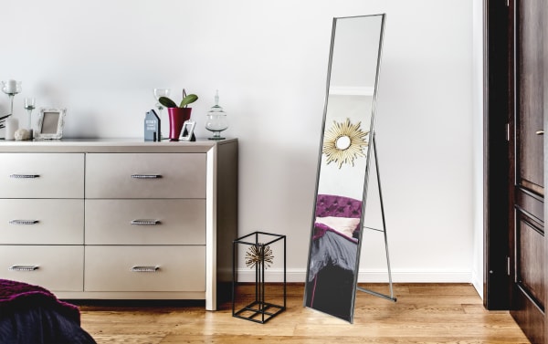 Bethany Brushed Steel Floor Mirror with mid-century modern style, powder-coated champagne steel frame, beveled glass, and foldable design for bedroom or closet.