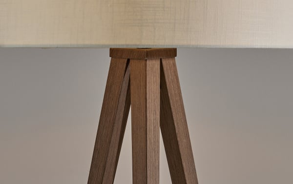 Milana 60.3'' Walnut Floor Lamp with walnut wood grain tripod steel legs, off-white fabric drum shade, and hidden black cord in cottage style.