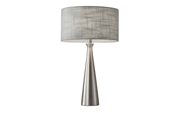 Lisette Brushed Steel Table Lamp with gray fabric drum shade, mid-century modern style, brushed steel tapered base, and clear cord.