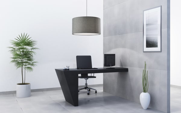 Stracelen Charcoal Large Drum Pendant light in mid-century modern style with gray cotton fabric shade, steel frame, and white diffuser, hanging over a minimalist office desk.