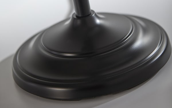 Close-up of the charcoal black steel base of the Alesandra 60'' Mid-Century Modern floor lamp, featuring a turned metal pole and smooth matte finish.