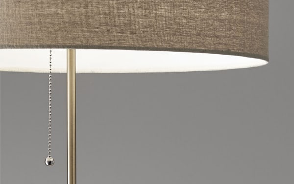 Mid-century modern Alliston floor lamp with taupe linen fabric shade, antique brass pull chain, and walnut eucalyptus wood accents.