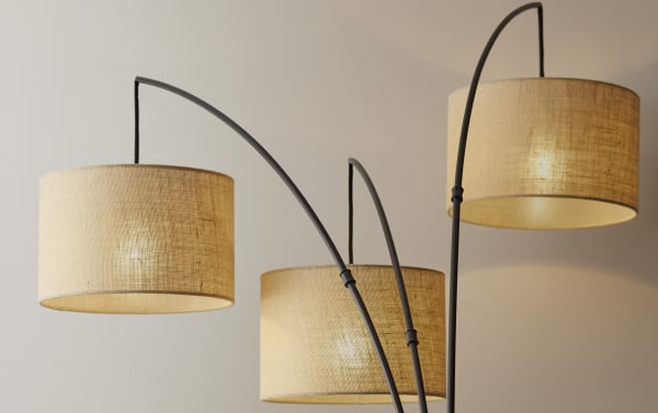 Caronia 84'' Antique Bronze Arc Floor Lamp with three taupe burlap fabric shades, cottage style, steel arms, and warm tan finish.