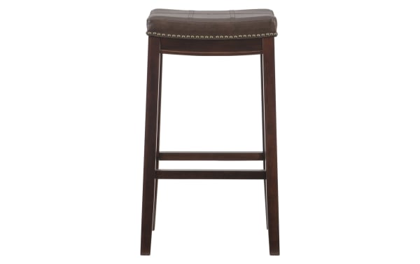 Ryann Brown Faux Leather Backless Bar Height Stool with dark brown rubberwood frame, cushioned polyurethane seat, and antique brass nailhead trim.