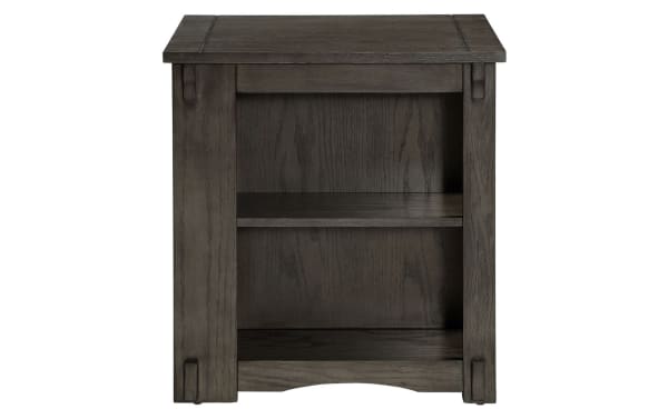 Transitional Christy Gray Storage Cabinet Side Table in dark gray rubberwood solids with two open shelves, decorative carved legs, and a simple rectangular top.