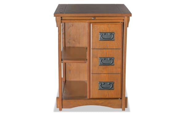 Christy Brown Storage Cabinet Side Table in transitional style with warm brown particle board, MDF, and rubberwood solids, featuring three drawers with traditional metal handles, two open shelves, and a pull-out ledge top for versatile storage.