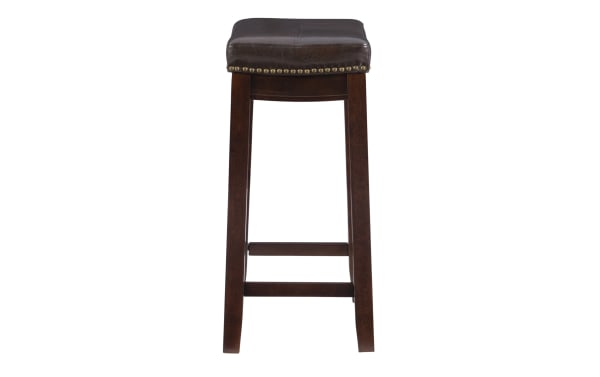 Cielo Brown faux leather backless counter height stool with deep brown rubberwood frame, antique brass nailhead trim, and double needle stitching.