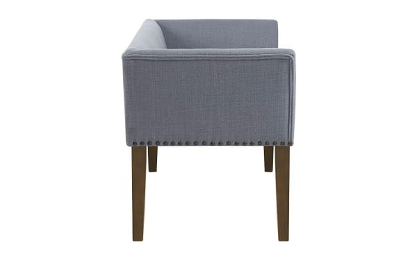 Contemporary Cecile Light Blue Bench with slate blue polyester fabric, bronze nailhead trim, low back, flared arms, and solid light wood legs.
