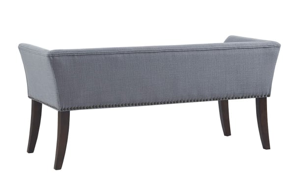 Contemporary Cecile Light Blue Bench with slate blue polyester fabric, bronze nailhead trim, flared arms, low back, and dark solid wood legs.
