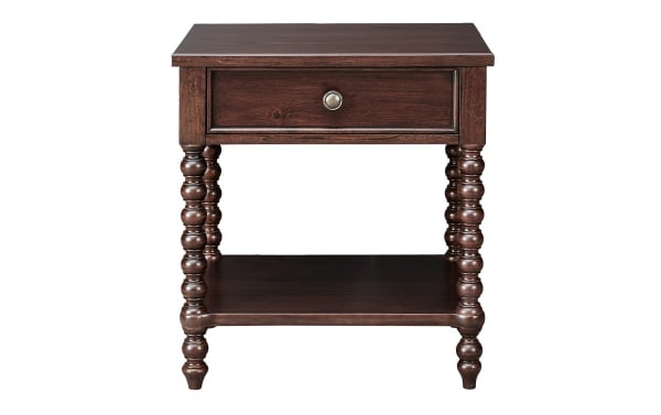 Padme Brown Nightstand with Drawer in traditional farmhouse style, made of acacia veneers with a natural brown finish, featuring turned solid wood legs, a single drawer with metal knob, and a lower shelf for bedside storage.