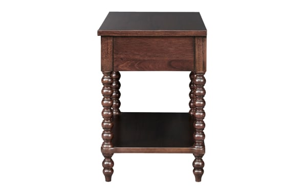 Padme Brown Nightstand with Drawer in traditional style, made of acacia veneers with a natural finish, featuring turned solid wood legs and a lower shelf.