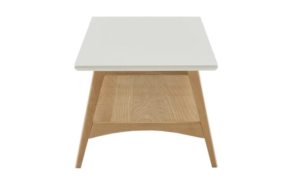 Mid-century modern Marcie Natural Solid Wood Coffee Table with off-white manufactured wood top, solid wood frame, and lower storage shelf.