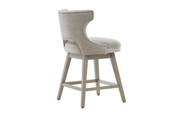 Kaya Light Gray Upholstered Counter Height Swivel Stool with solid wood legs, light gray fabric, pewter nailhead trim, and 360° swivel function in transitional style.