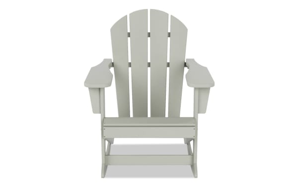 White Outdoor Sand Rocking Adirondack Chair in transitional style, made of durable high-density plastic with wide armrests and slatted back for rustic outdoor seating.