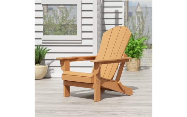Outdoor brown folding Adirondack chair in transitional style, made of high-density plastic with slatted back and wide armrests, foldable for easy storage.