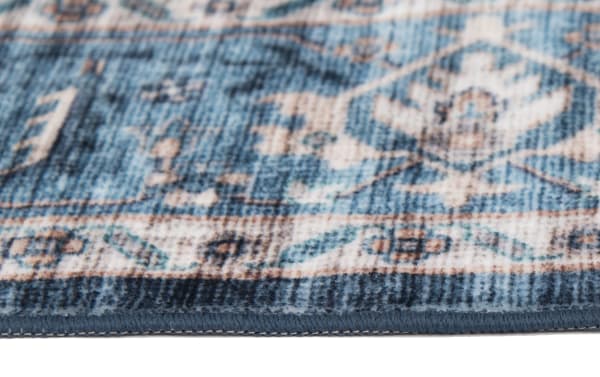 Navy, light blue, and ivory transitional Teller 8' x 10' washable rug with polyester fabric, featuring a detailed oriental pattern and durable, stain-resistant design.