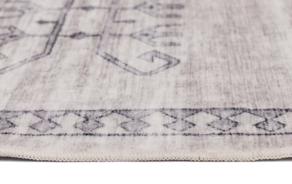 Light gray transitional 5' x 7' Altis vintage rug with subtle geometric border pattern, made of durable polyester fabric.