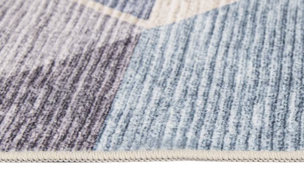 Close-up of Kwesi 8' x 10' Purple Oriental Washable Rug showing beige and blue transitional polyester fabric with textured woven pattern and reinforced edge.