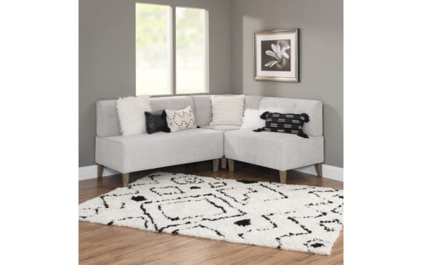 Lindie Light Gray Corner Bench with soft gray tweed polyester fabric upholstery, foam cushions, and natural rubberwood legs in transitional style.