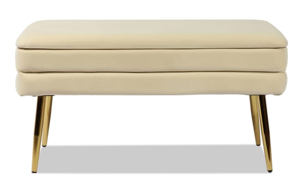 Contemporary Astrid Cream Storage Bench with plush velvet upholstery, channel-tufted cream fabric, and sleek polished gold stainless steel legs.
