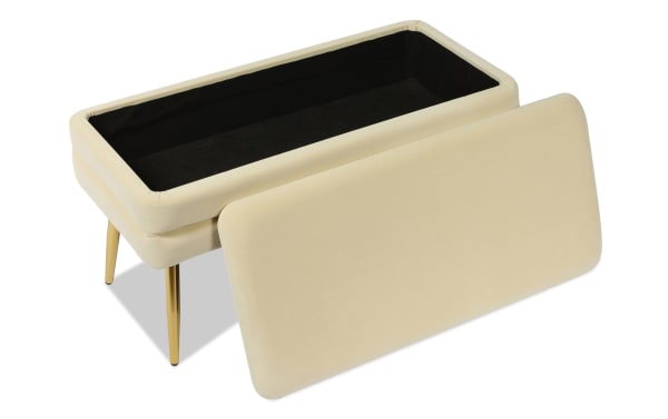 Contemporary Astrid Cream Storage Bench with cream velvet upholstery, channel-tufted design, and polished gold stainless steel legs for elegant seating and storage.