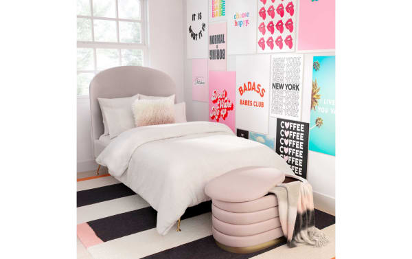 Larson Blush Velvet Storage Bench in pink velvet with channel-tufted design and gold stainless steel base, offering stylish mid-century storage and seating.
