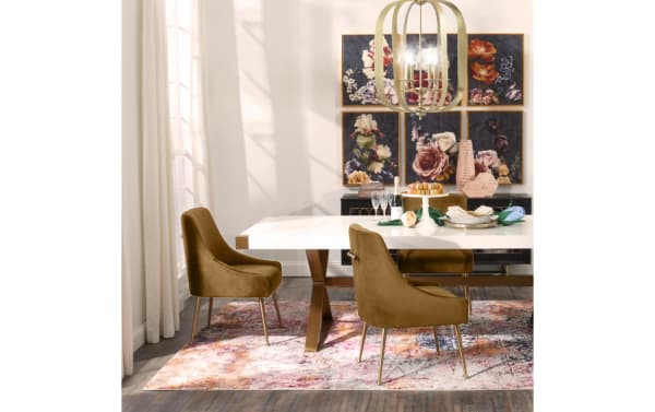 Contemporary Giselle II Cognac brown velvet dining chair with solid back, gold stainless steel legs, and back handle for luxe glamour.
