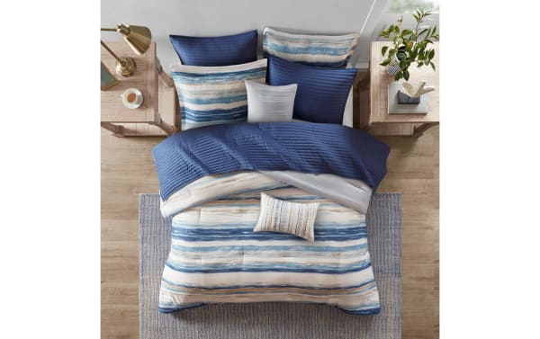 Lucas Full/Queen Blue Abstract 8 Piece Comforter Set with microfiber fabric, featuring blue and white sea-inspired stripes, extra lightweight blanket, and transitional style for a calming bedroom oasis.