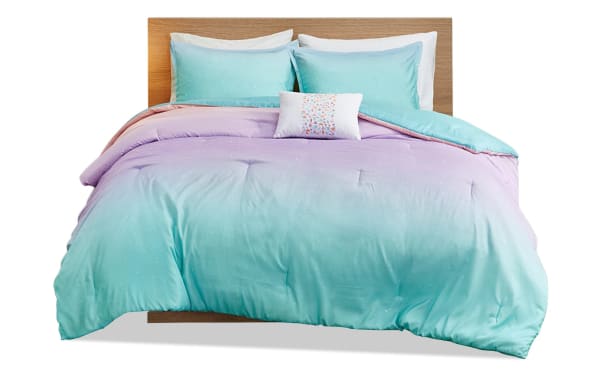 Shimmer Twin/Twin XL reversible 3-piece comforter set in light blue and blush polyester fabric with subtle fairy dust sparkles, contemporary style.