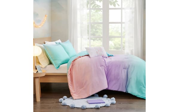 Contemporary Shimmer Twin/Twin XL reversible 3-piece comforter set in light blue and blush polyester fabric with subtle fairy dust sparkles, ideal for bedrooms or dorm rooms.