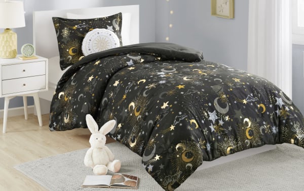 Despia Starry Sky Full/Queen Charcoal Novelty Reversible 4 Piece Comforter Set features a glam microfiber polyester fabric in charcoal with gold, white, and gray celestial designs including stars, moons, and planets, perfect for a cosmic-themed bedroom.