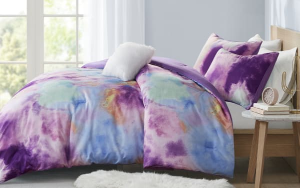 Gaze Full/Queen Purple Abstract Reversible 4 Piece Comforter Set with microfiber polyester fabric, featuring a contemporary lavender color palette of purple, pink, blue, turquoise, and orange abstract patterns, including matching pillow shams and a white fluffy accent pillow.