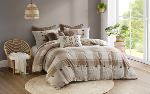 Aspen Lodge King Beige Plaid 9 Piece Comforter Set with oversized cotton jacquard comforter, button details, matching shams, and textured decorative pillows in cream, brown, and beige farmhouse style.