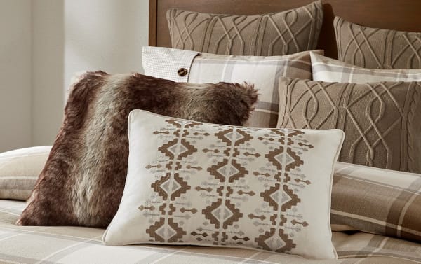 Aspen Lodge King Beige Plaid 9 Piece Comforter Set with cream, brown, and beige cotton blend fabric. Features oversized plaid cotton jacquard comforter, button details, matching plaid shams, knitted Euro shams, and decorative pillows in faux fur, ikat embroidery, and knit textures for a cozy farmhouse bedroom look.