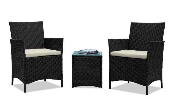 Mikado 3 Piece Cream Wicker Conversation Set with two black iron and steel armchairs, cream polyester cushions, and a tempered glass-top wicker side table, perfect for outdoor patios.