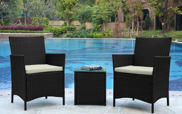 Mikado 3 Piece Cream Wicker Conversation Set with two black iron and steel armchairs, cream polyester cushions, and a tempered glass-top end table in transitional style.