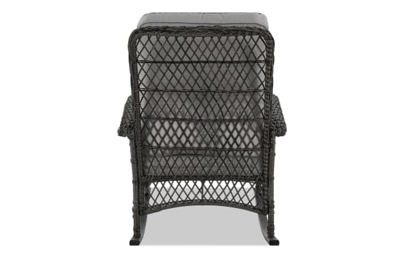 Back view of Pianco Gray Wicker Outdoor Rocking Chair in gray polyester fabric with iron and steel frame, featuring classic rattan weave and curved edges.