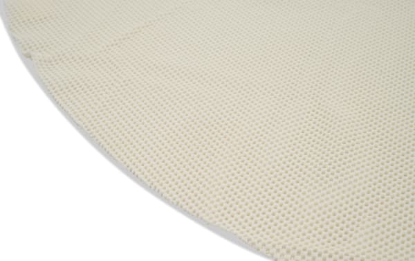 Beige fabric surface of Bob's 5' Round Magic Rug Pad with textured polyester material, designed for cushioning and floor protection.