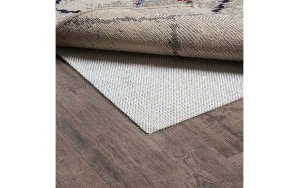Beige 9' x 12' Bob's Magic Rug Pad in transitional style, made of cushioned polyester fabric, designed to prevent wood floor scratches and secure rugs.