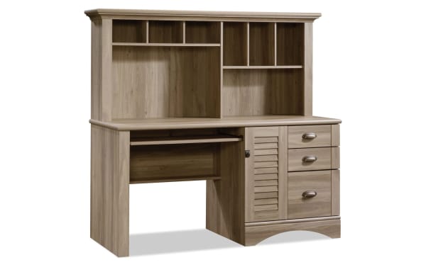 Transitional Cove 3 Drawer Oak Desk in light wood particle board and MDF with hutch, cubby shelves, slide-out keyboard tray, vertical CPU space, and three drawers.