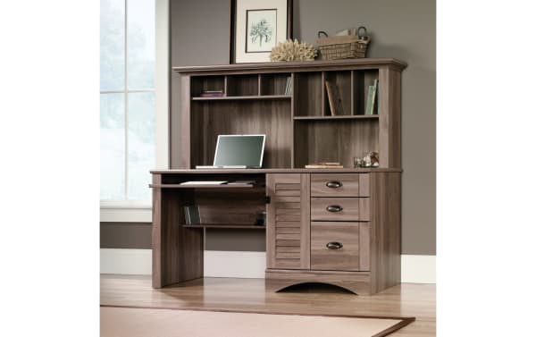 Transitional Cove 3 Drawer Oak Desk in gray-brown particle board and MDF, featuring a hutch with cubby shelves, slide-out keyboard tray, vertical CPU space, and three drawers for versatile home office storage.
