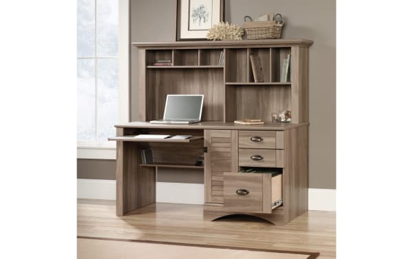 Transitional Cove 3 Drawer Oak Desk with hutch in light oak particle board and MDF, featuring cubby shelves, slide-out keyboard tray, vertical CPU space, and three drawers for home office storage.