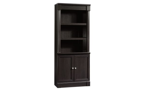 Tall dark wood bookshelf with two open shelves and a two-door cabinet base, featuring silver handles and decorative side columns.
