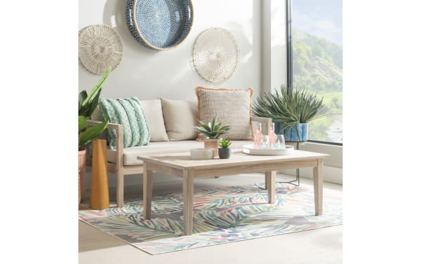Gardner Natural Outdoor Coffee Table in transitional style, solid acacia wood with natural oil stain, slatted top, and sturdy base for indoor/outdoor use.