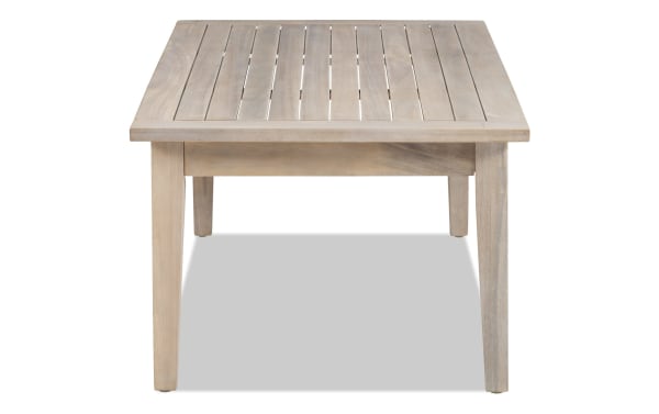 Gardner Natural Outdoor Coffee Table in transitional style, made of solid acacia wood with a slatted top and natural oil stain for rustic durability.