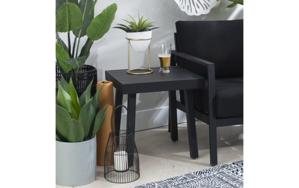 Suvi Black Aluminum Outdoor Side Table from Suvi Outdoor collection, transitional style, black powder-coated aluminum and steel, rust-resistant, lightweight patio side table with slatted top supporting drinks and decor.