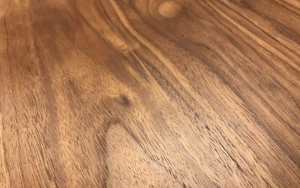 Walnut veneer surface of Maderna Brown End Table showcasing natural wood grain texture in industrial Scandinavian style.