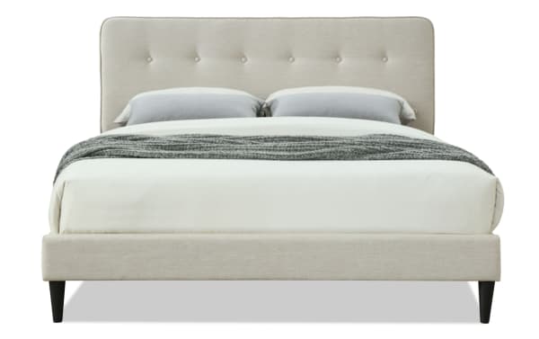 Lila King beige upholstered platform bed with button tufted headboard, tapered wood legs, and soft polyester fabric in transitional style.